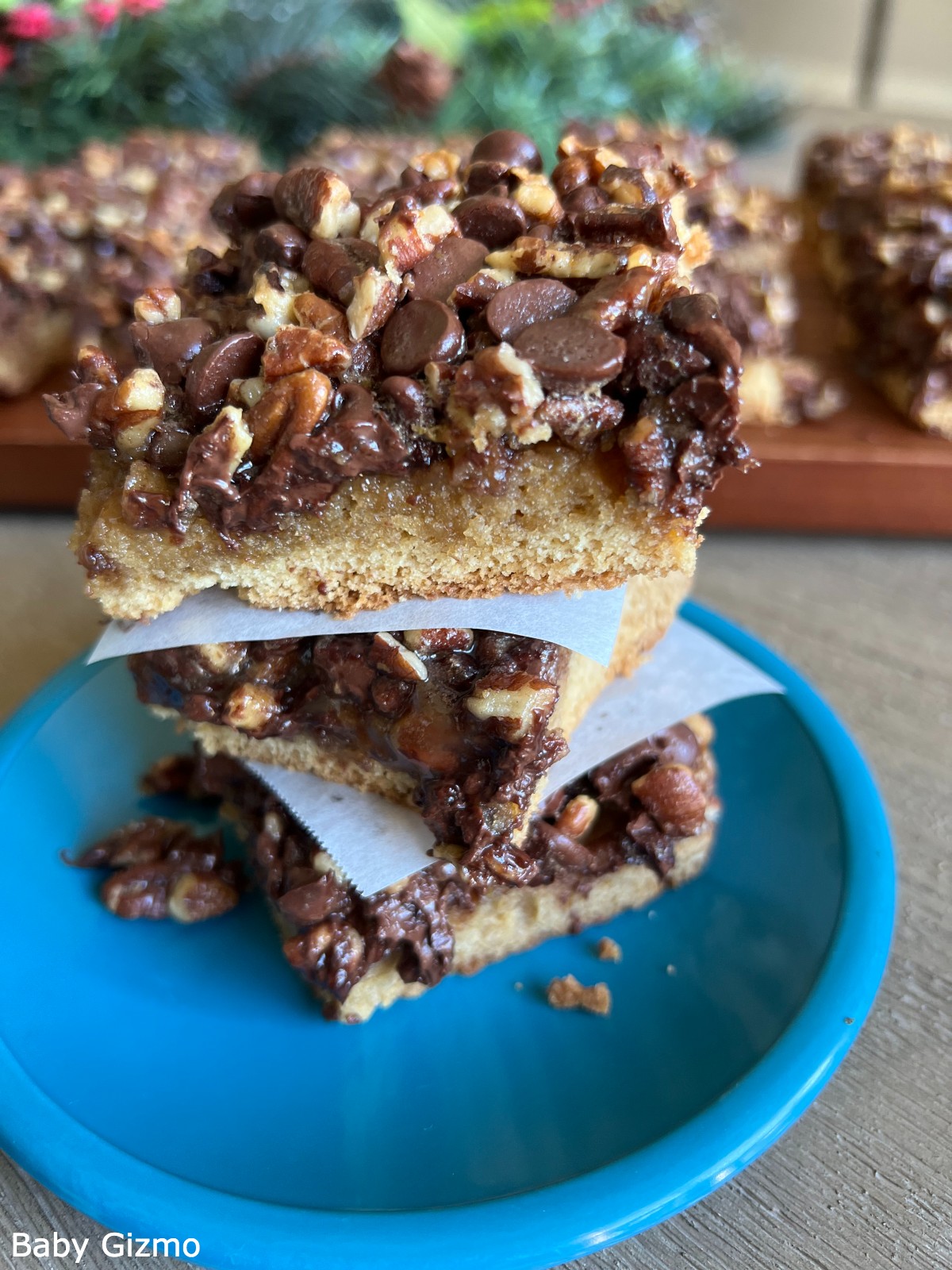 pecan pie bars stacked on blue plate